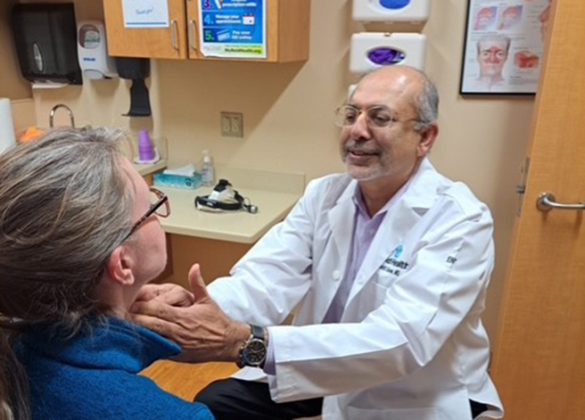 Reid Health's Dr. Rohit Bawa examining a patient